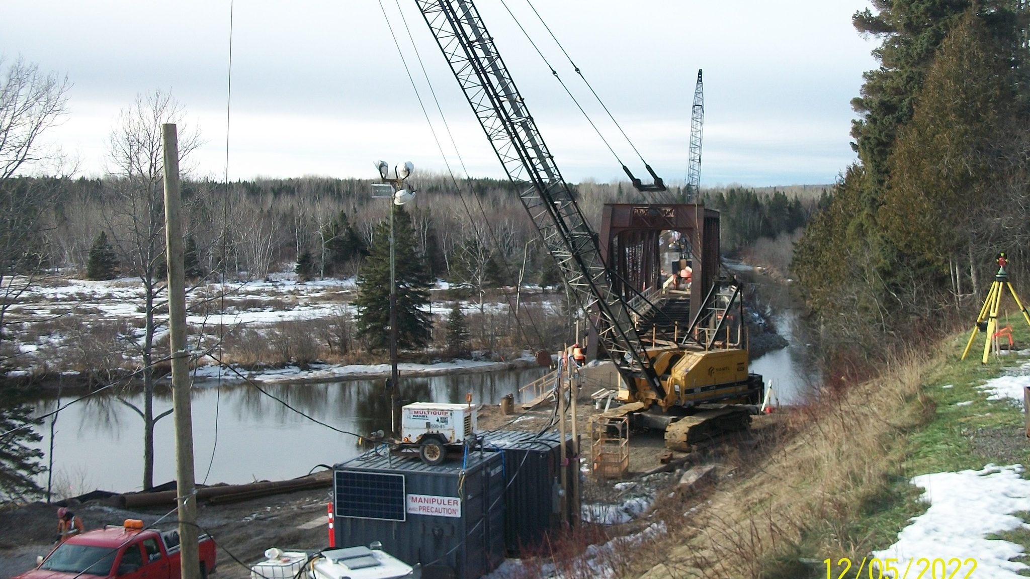 A large crane is being used to repair the railway bridge at Little Port-Daniel River